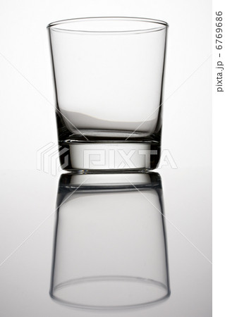 An empty glass on a grey background An empty glass on a grey background 6769686