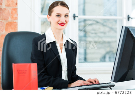 Lawyer in office making notes in a file 6772228