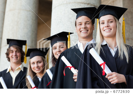 Close-up of five smiling graduates posing Close-up of five smiling graduates posing 6772630