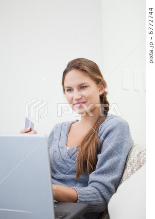 Woman sitting while using a computer 6772744