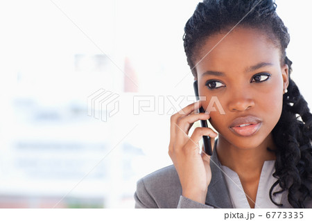 Young employee looking towards the side while talking on the pho 6773335