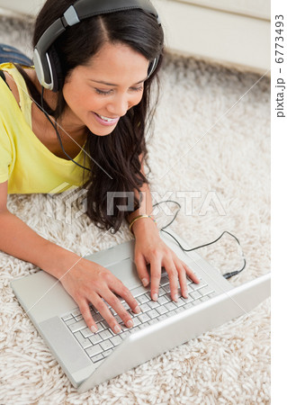 Close-up of a smiling Latin chatting on a laptop Close-up of a smiling Latin chatting on a laptop 6773493