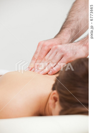 Close-up of woman being massaged by a doctor Close-up of woman being massaged by a doctor 6773665