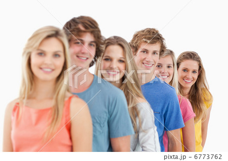 A smiling group standing behind each other at an angle A smiling group standing behind each other at an angle 6773762
