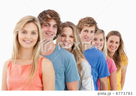A smiling group standing behind each other at an angle 6773783