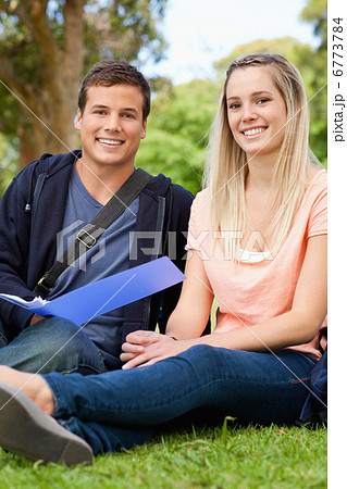 Portrait of a smiling tutor helping a teenager to revise Portrait of a smiling tutor helping a teenager to revise 6773784