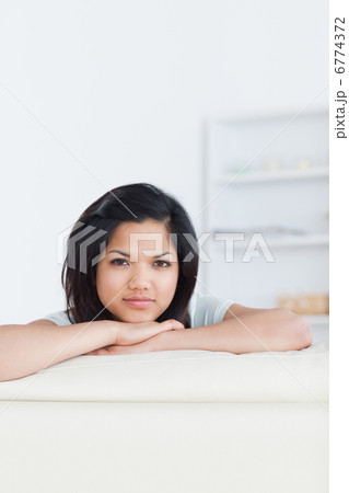 Woman crossing her arms and resting her head on them 6774372