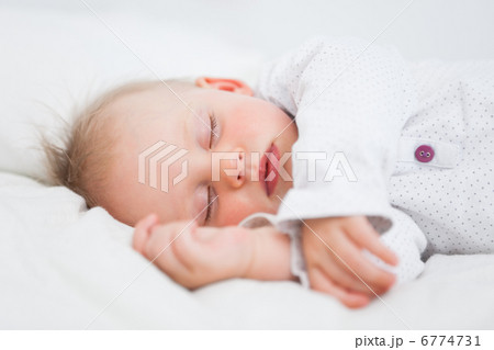 Cute baby sleeping while extending her arms Cute baby sleeping while extending her arms 6774731
