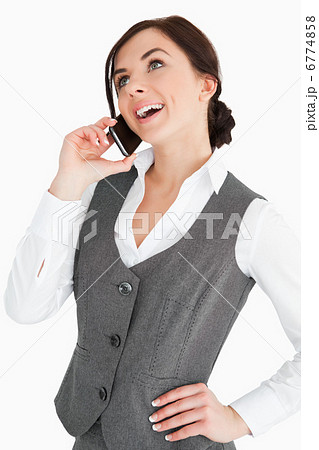 Happy well-dressed woman calling with a smartphone Happy well-dressed woman calling with a smartphone 6774858