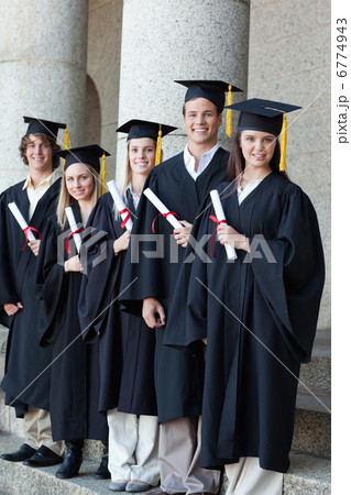 Happy graduates posing in single line 6774943