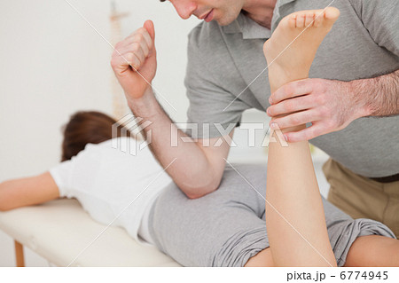 Woman lying while being massaged by her doctor 6774945
