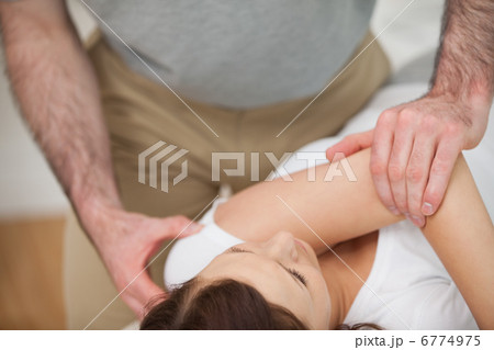 Osteopath making a joint mobilisation 6774975