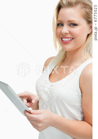 Cheerful blonde woman touching her tablet computer Cheerful blonde woman touching her tablet computer 6775025
