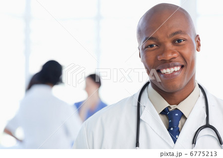 Smiling doctor standing with his stethoscope around his neck 6775213