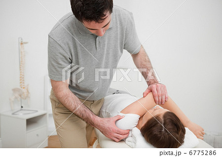 Patient lying on a medical table while being stretched 6775286
