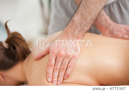 Woman lying on the belly while being massaged on his back Woman lying on the belly while being massaged on his back 6775307
