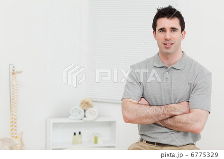 Peaceful doctor crossing his arms 6775329