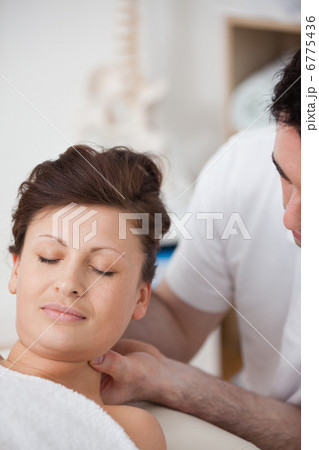 Woman being massaging her head while raising it Woman being massaging her head while raising it 6775436