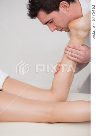 Chiropractor massaging the calf of his patient Chiropractor massaging the calf of his patient 6775462