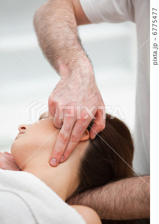 Therapist pressing with two fingers on the neck of his patient Therapist pressing with two fingers on the neck of his patient 6775477