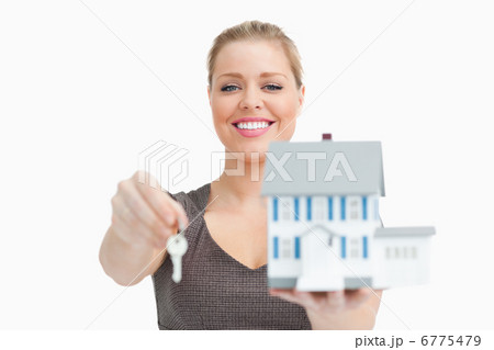 Model house and a key holding by a woman 6775479