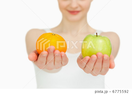 Close up of a woman presenting fruits Close up of a woman presenting fruits 6775592
