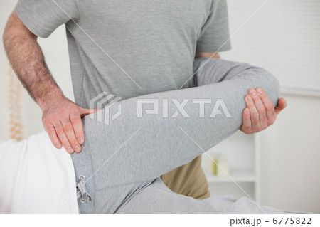 Chiropractor stretching the leg of a patient Chiropractor stretching the leg of a patient 6775822