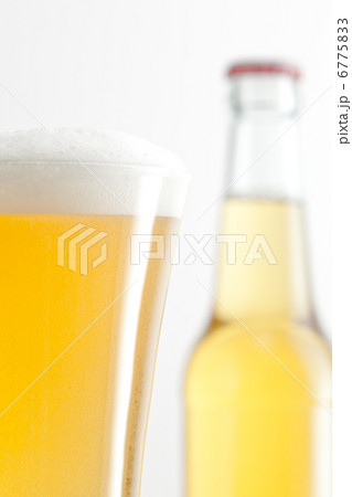 Bottle and glass of beer against a white background 6775833