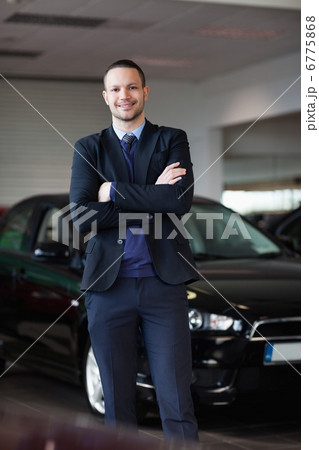 Salesman standing in front of car 6775868