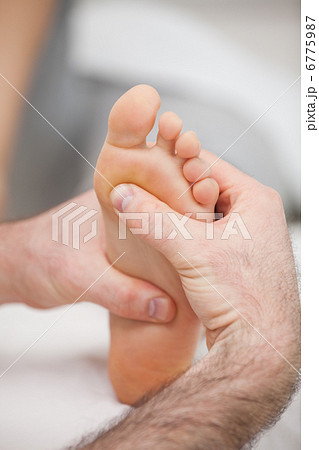 Sole of foot being massaged 6775987