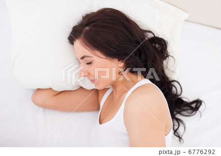 Brunette woman lying on the side while sleeping Brunette woman lying on the side while sleeping 6776292
