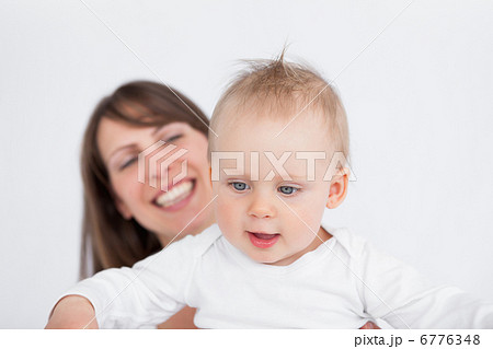 Happy mother holding her cute baby Happy mother holding her cute baby 6776348