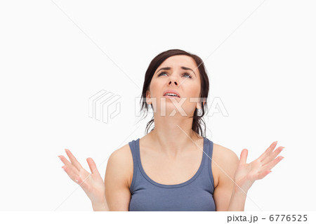 Young woman begging while looking up Young woman begging while looking up 6776525