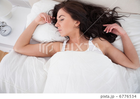 Woman sleeping in her bed in the morning 6776534