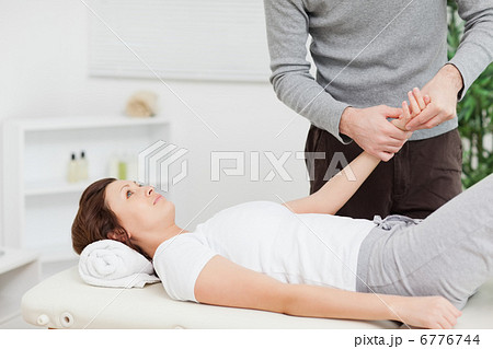 Physiotherapist massaging the hand of a woman 6776744