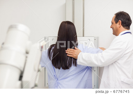 Doctor proceeding a mammography on a patient 6776745