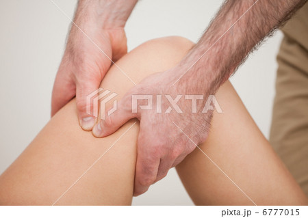 Knee of a patient being held by a physiotherapist 6777015