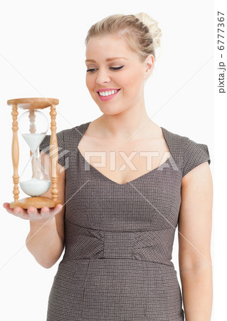 Woman looking a hourglass on her hand Woman looking a hourglass on her hand 6777367