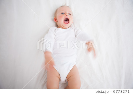 Little girl shouting while lying on a blanket Little girl shouting while lying on a blanket 6778271