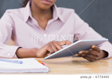 Close up of a teacher using a tablet computer 6778460