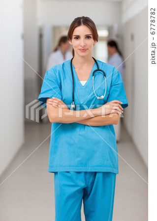 Nurse folding her arms while standing 6778782