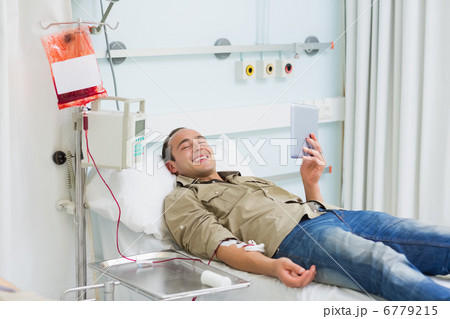 Smiling transfused patient looking at a tablet computer Smiling transfused patient looking at a tablet computer 6779215