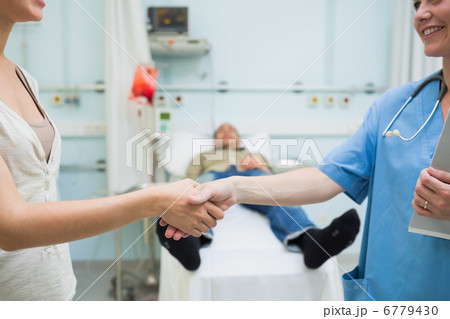 Nurse shaking hand of a patient 6779430