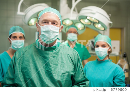 Smiling surgeon posing with a team 6779800