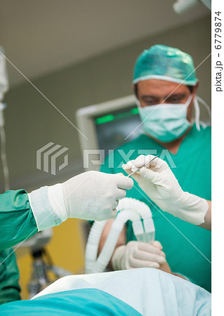 Surgeons holding a scalpel 6779874