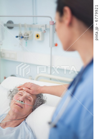 Patient lying on a bed closes her eyes 6779921