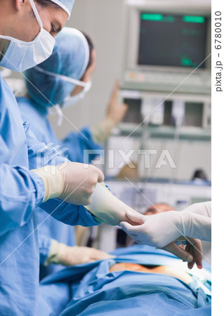 Doctor removing his gloves Doctor removing his gloves 6780010