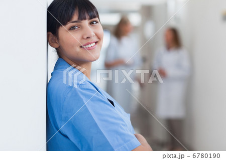 Nurse looking at camera in corridor Nurse looking at camera in corridor 6780190