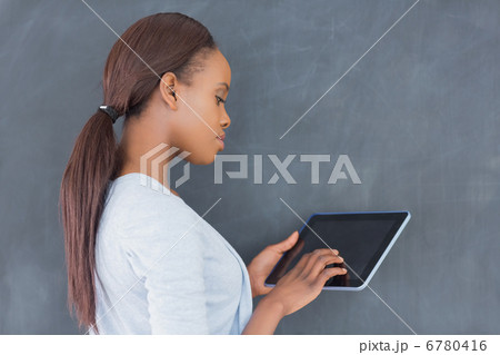 Side view of a woman using a tablet computer Side view of a woman using a tablet computer 6780416