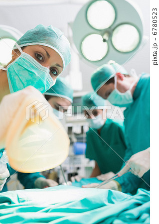 Focus on a nurse holding an anesthesia mask 6780523
